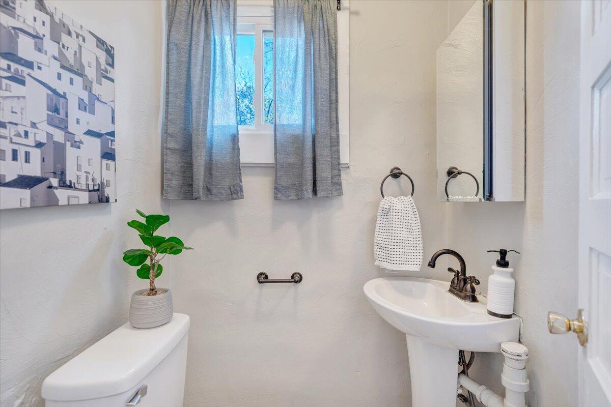 1008 5th Street Southeast Roanoke, VA 24013 - Photo 20 of 60 a bathroom with a sink a toilet and a mirror