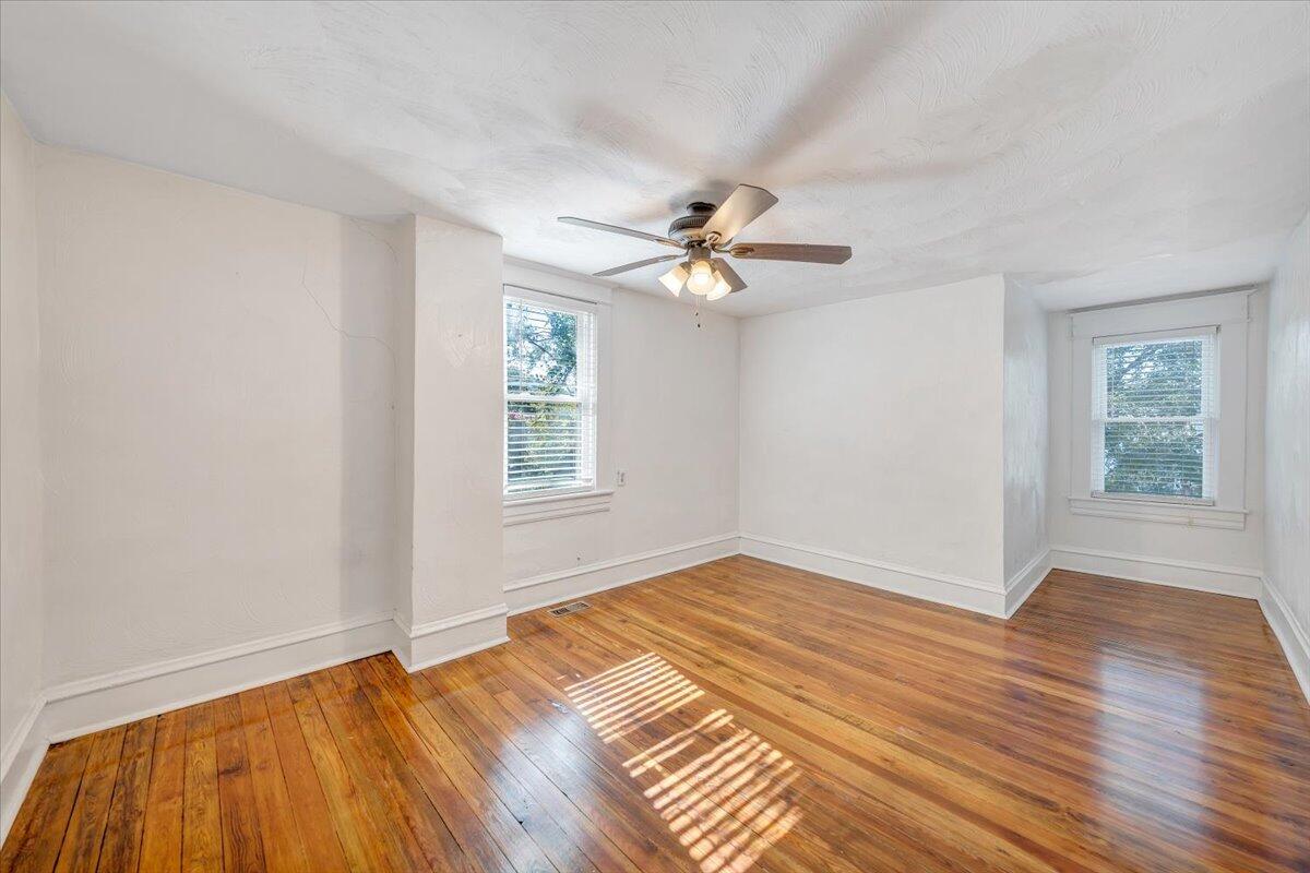 1008 5th Street Southeast Roanoke, VA 24013 - Photo 24 of 60 a view of an empty room with wooden floor and a window