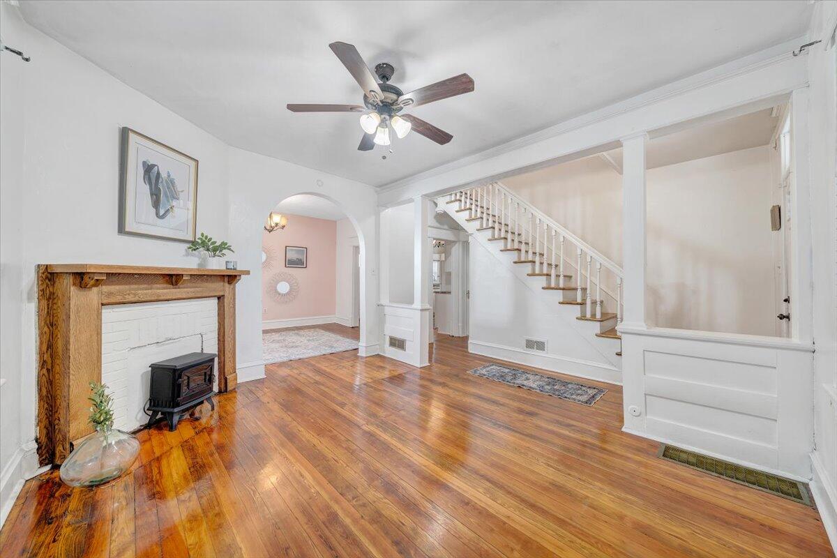 1008 5th Street Southeast Roanoke, VA 24013 - Photo 5 of 60 a view of an empty room with wooden floor fireplace and a window