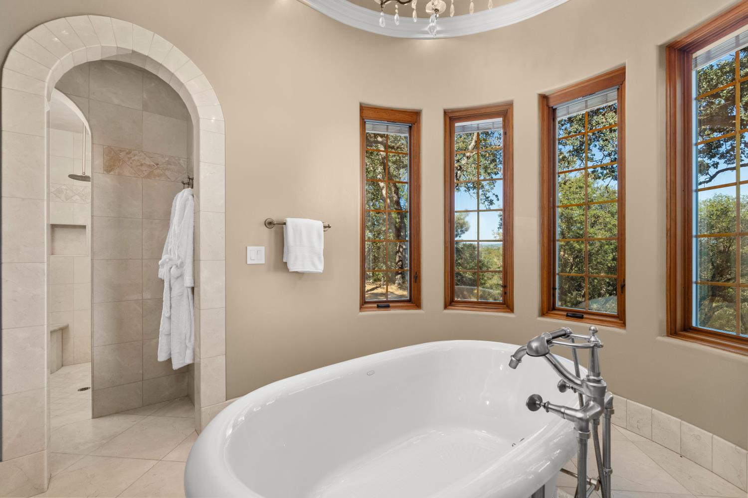 1100 Cold Springs Road Placerville, CA 95667 - Photo 38 of 97 Primary Bathroom - Freestanding soaking tub with chrome fixtures, surrounded by multiple casement windows with wood frames