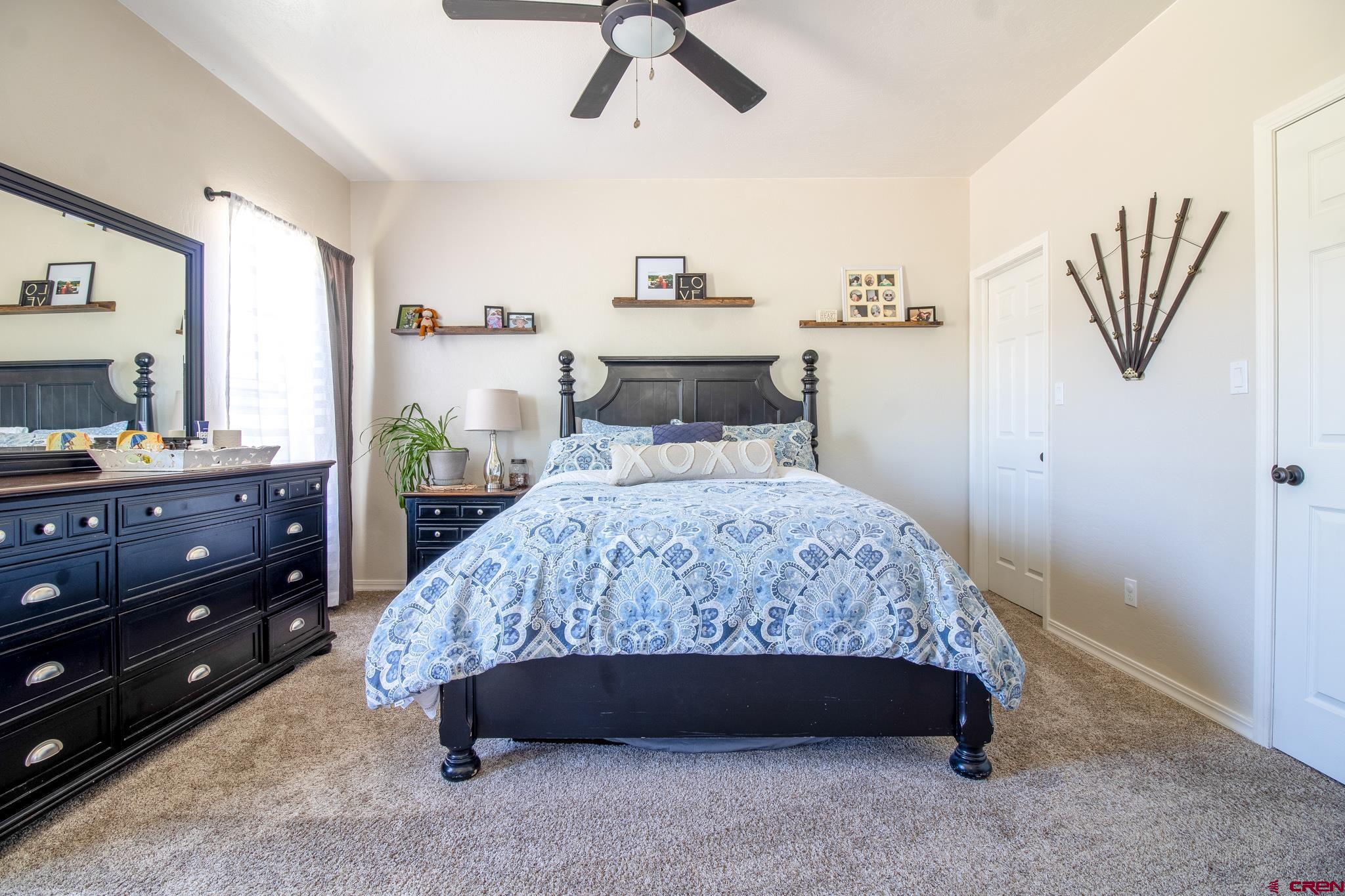 42168 Rd J Mancos, CO 81328 - Photo 13 of 30 a bedroom with a bed and a table in it