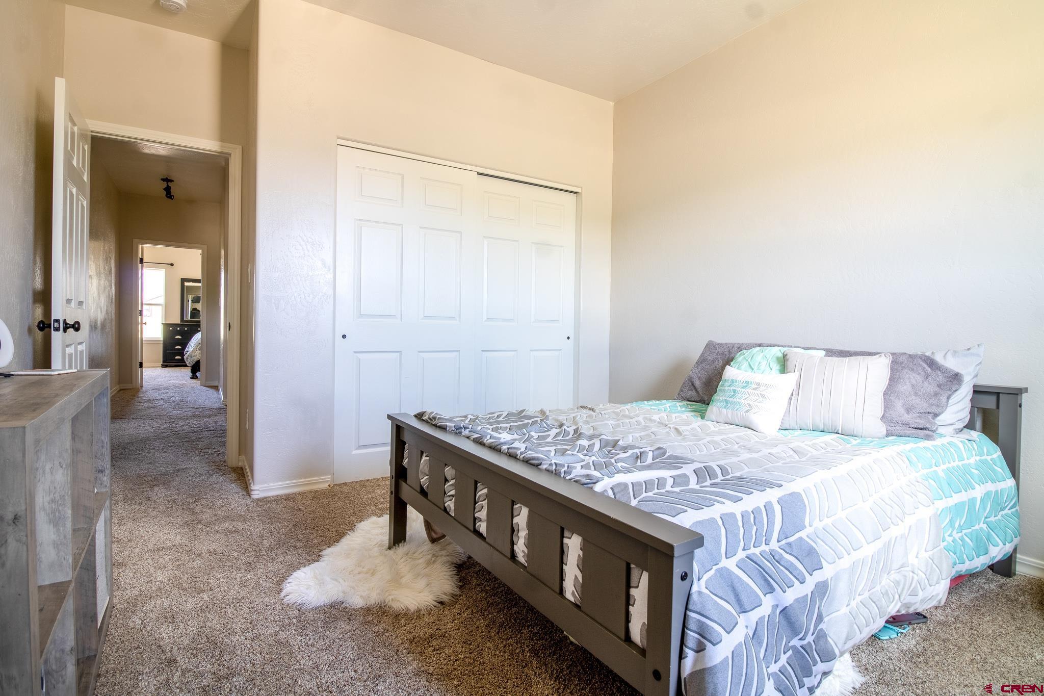 42168 Rd J Mancos, CO 81328 - Photo 16 of 30 a bedroom with a bed and a table in it