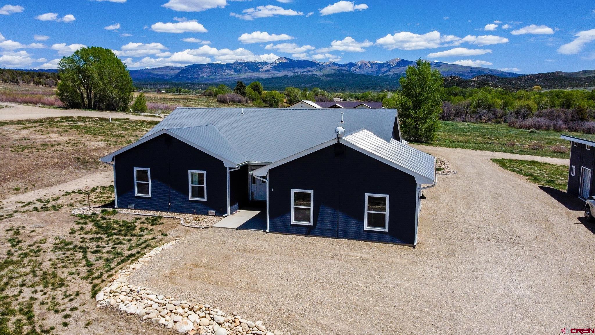 42168 Rd J Mancos, CO 81328 - Photo 3 of 30 a front view of a house with a yard