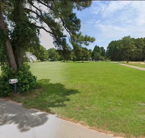 a view of a field with an trees