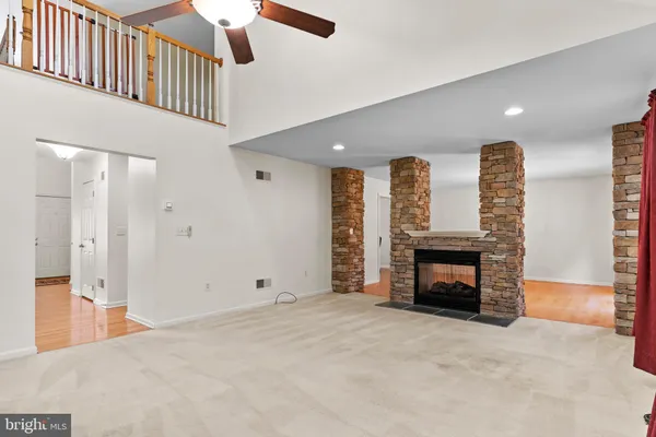 a view of an empty room and fire place