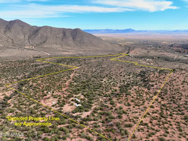 a view of a large building with mountain in the background