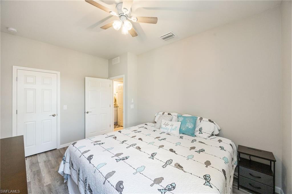 6125 Triumph Lane Ave Maria, FL 34142 - Photo 16 of 31 Bedroom featuring light wood-style floors and ceiling fan