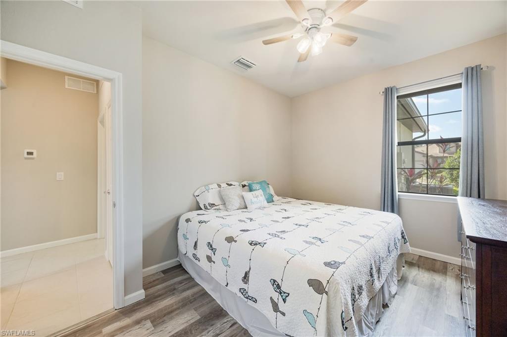 6125 Triumph Lane Ave Maria, FL 34142 - Photo 17 of 31 Bedroom with light wood finished floors and ceiling fan