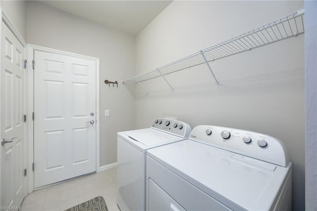 6125 Triumph Lane Ave Maria, FL 34142 - Photo 19 of 45 Laundry area with independent washer and dryer and light tile patterned flooring