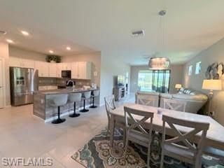 6125 Triumph Lane Ave Maria, FL 34142 - Photo 3 of 45 a view of a dining room with furniture