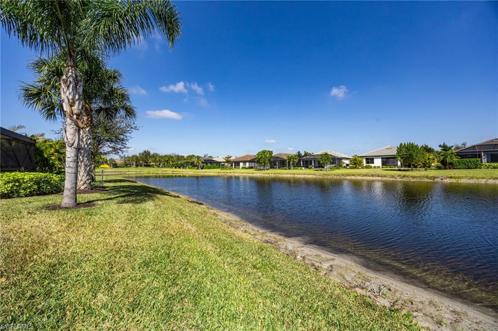 6125 Triumph Lane Ave Maria, FL 34142 - Photo 34 of 45 a view of a lake with houses in the back
