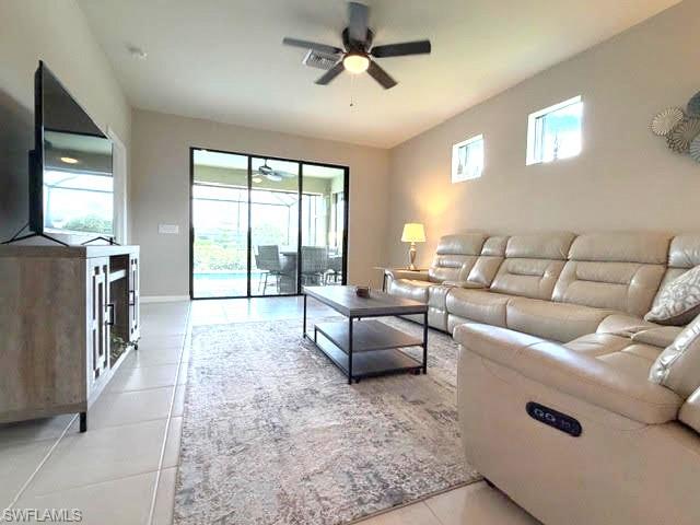 6125 Triumph Lane Ave Maria, FL 34142 - Photo 39 of 45 a living room with furniture and a flat screen tv