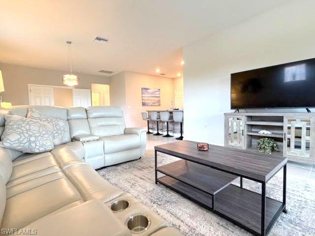 6125 Triumph Lane Ave Maria, FL 34142 - Photo 43 of 45 a living room with furniture and a flat screen tv