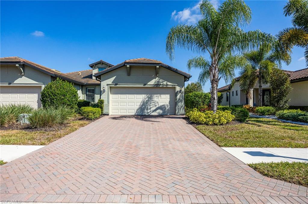 6125 Triumph Lane Ave Maria, FL 34142 - Photo 9 of 45 a front view of a house with a yard and potted plants