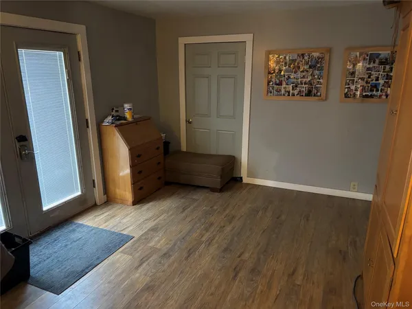 a view of room with window and wooden floor