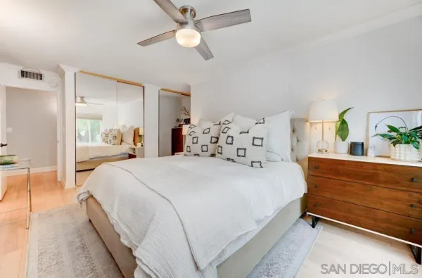 a bedroom with a bed and ceiling fan