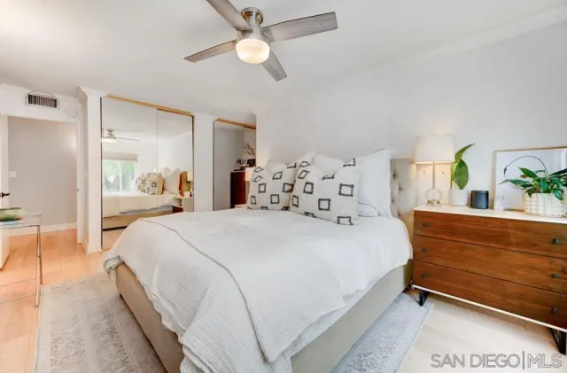 a bedroom with a bed and ceiling fan