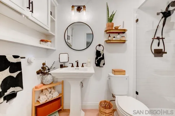 a bathroom with a sink mirror and toilet