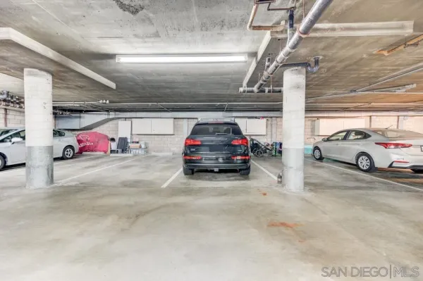 a view of parking garage with cars parked