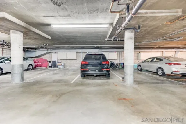 a view of parking garage with cars parked