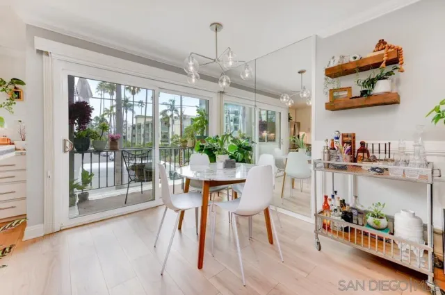 a dining room with furniture a chandelier and window