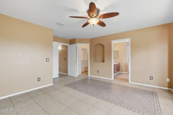 a view of a livingroom with a ceiling fan and window