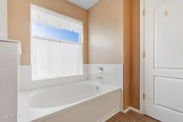 a white bath tub sitting next to a small window