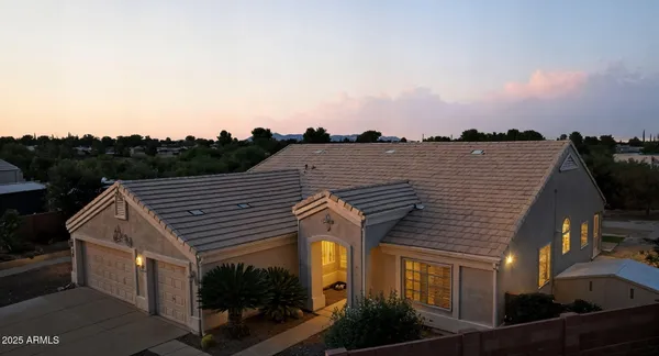 a view of a house with roof deck and seating space