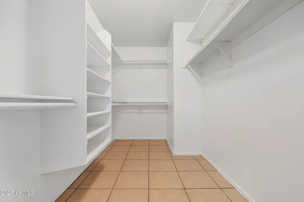 a view of a room with white walls and a shower