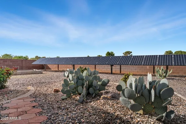a view of a pathway with a garden