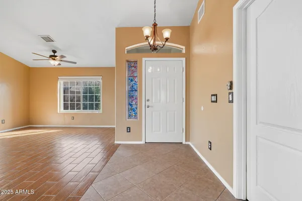 a view of a room with wooden floor and windows