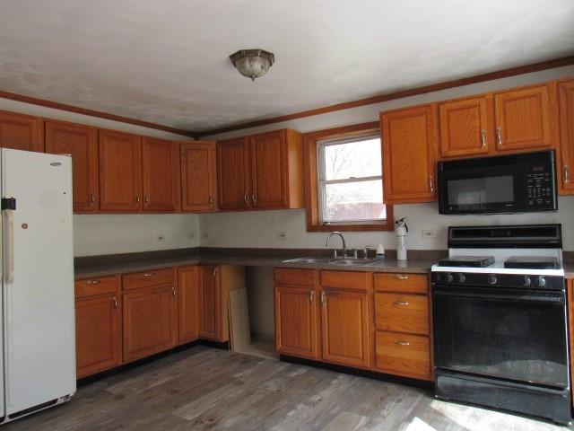 240 Main Street Dickerson Run, PA 15430 - Photo 12 of 20 a kitchen with granite countertop wooden cabinets stainless steel appliances and a window