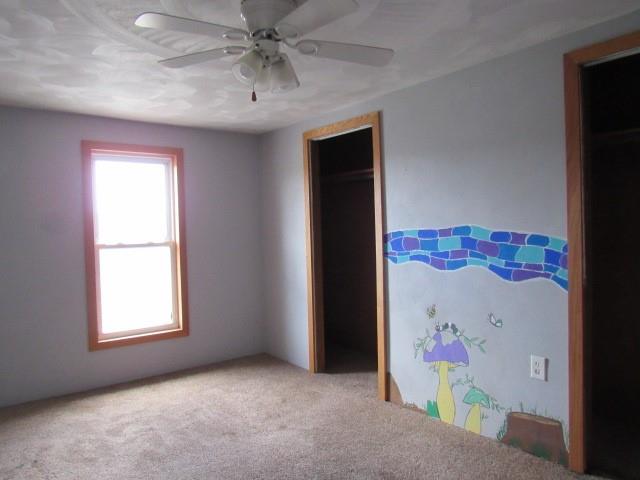 240 Main Street Dickerson Run, PA 15430 - Photo 13 of 20 an empty room with a ceiling fan and a window