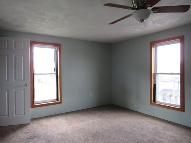 240 Main Street Dickerson Run, PA 15430 - Photo 15 of 20 an empty room with a window and a ceiling fan