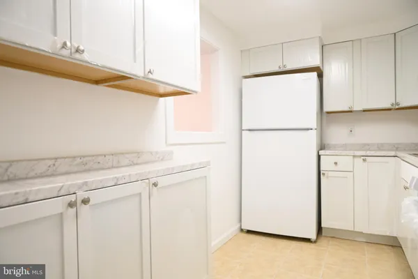 a utility room with cabinets washer and dryer