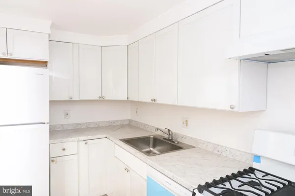 a kitchen with a sink cabinets and appliances