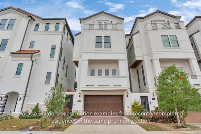 a front view of a residential houses with yard and parking