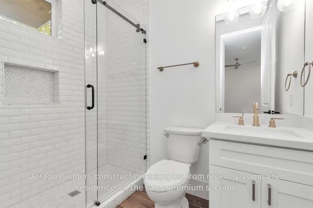 a bathroom with a double vanity sink a large mirror and shower