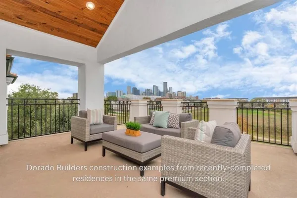 a roof deck with couches and potted plants