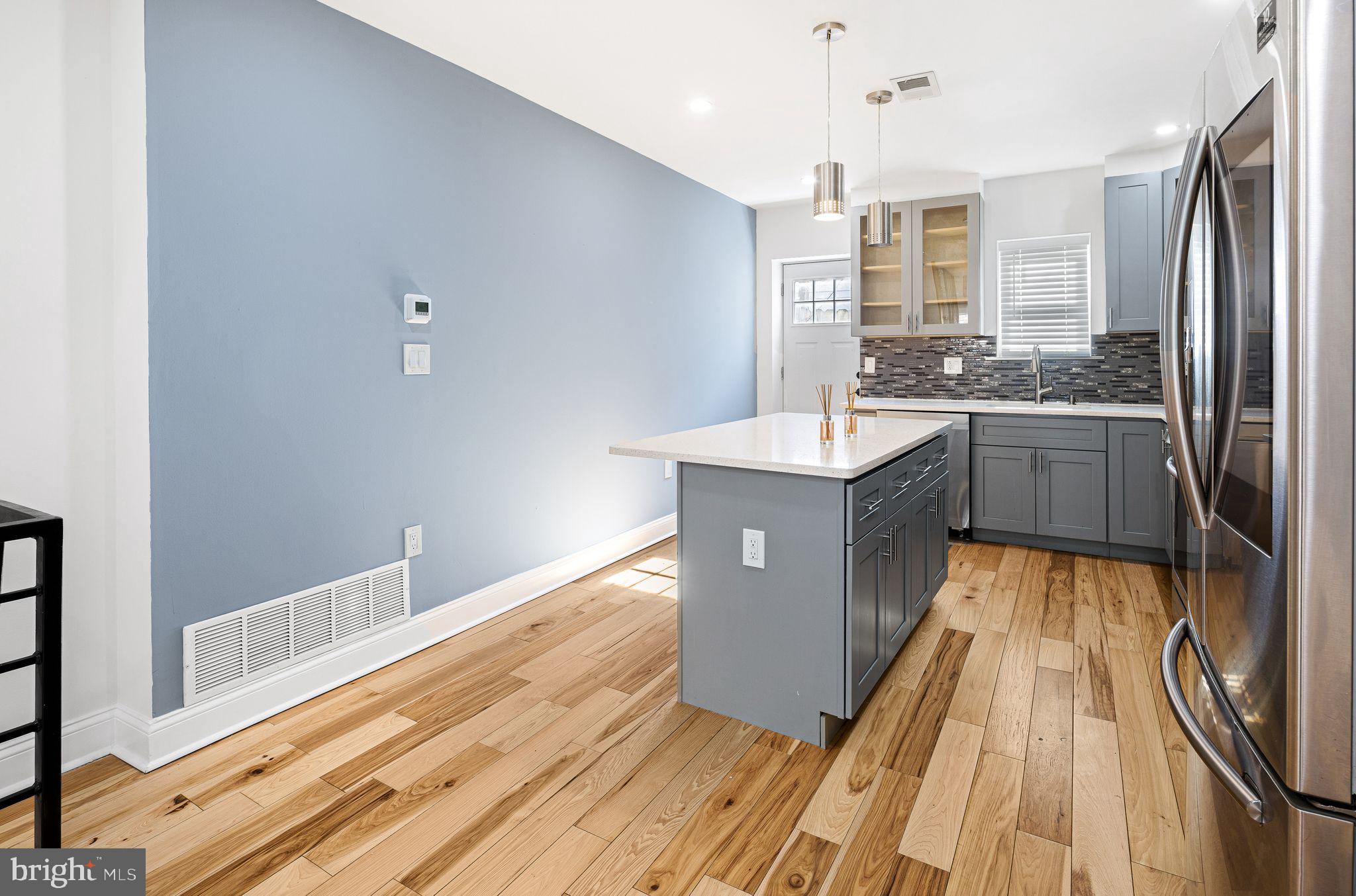 640 Emily Street Philadelphia, PA 19148 - Photo 4 of 15 a kitchen with kitchen island granite countertop a sink stove and refrigerator