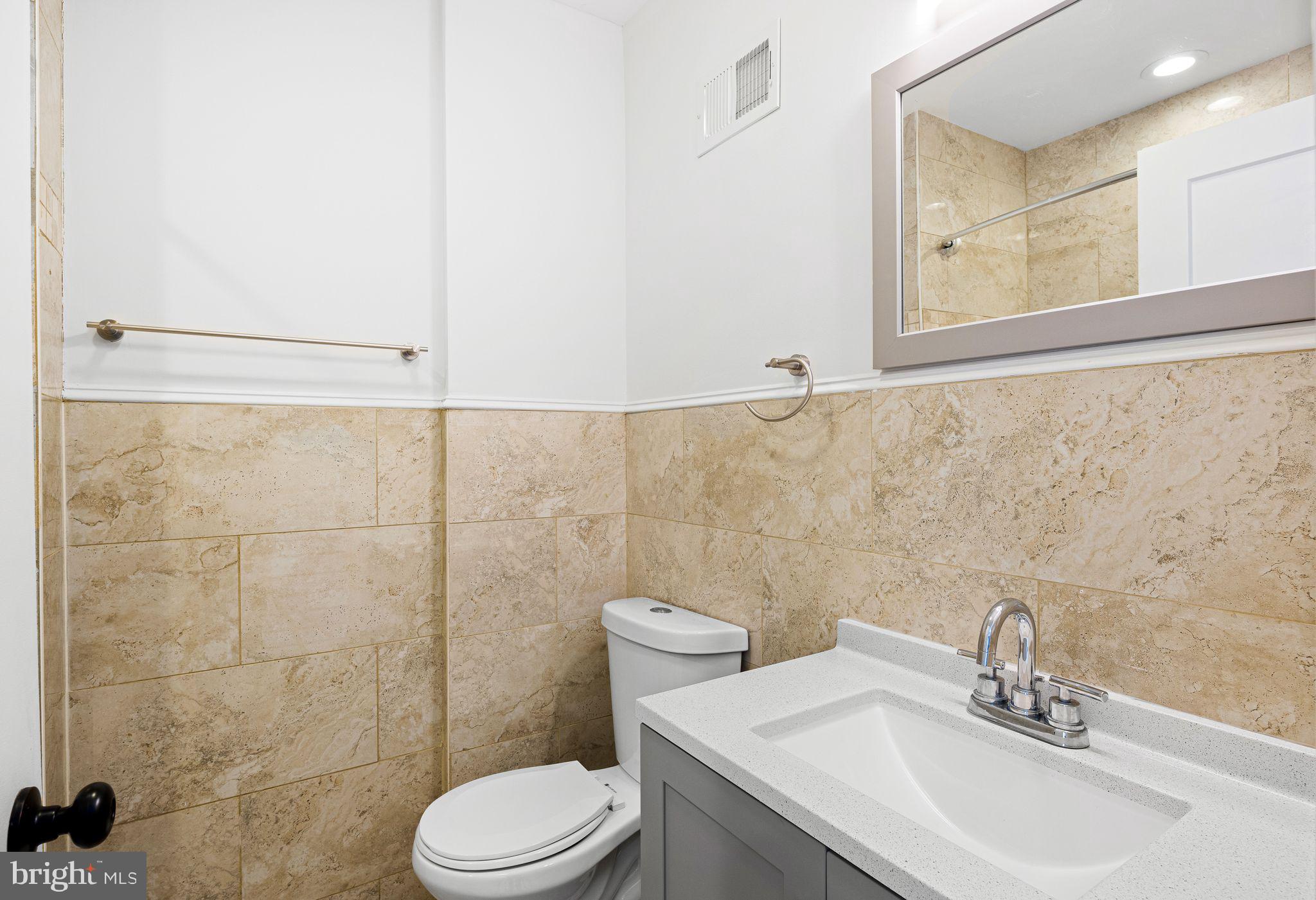 640 Emily Street Philadelphia, PA 19148 - Photo 6 of 15 a bathroom with a sink a toilet and a mirror