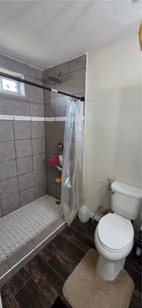 a bathroom with a toilet and shower