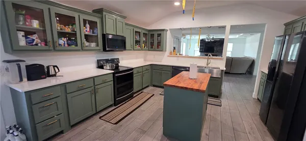a kitchen with stainless steel appliances granite countertop a sink and a stove top oven