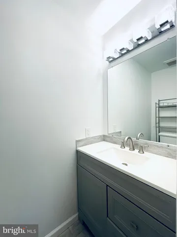 a bathroom with a toilet a sink and vanity