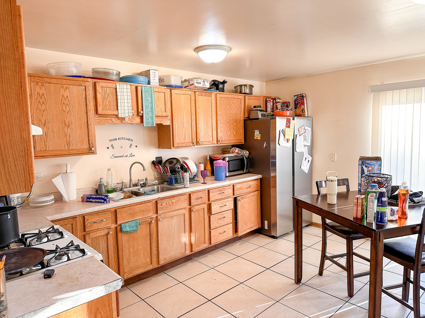 695 Moore Street Kankakee, IL 60901 - Photo 4 of 15 a kitchen that has a lot of cabinets a sink and a dining table
