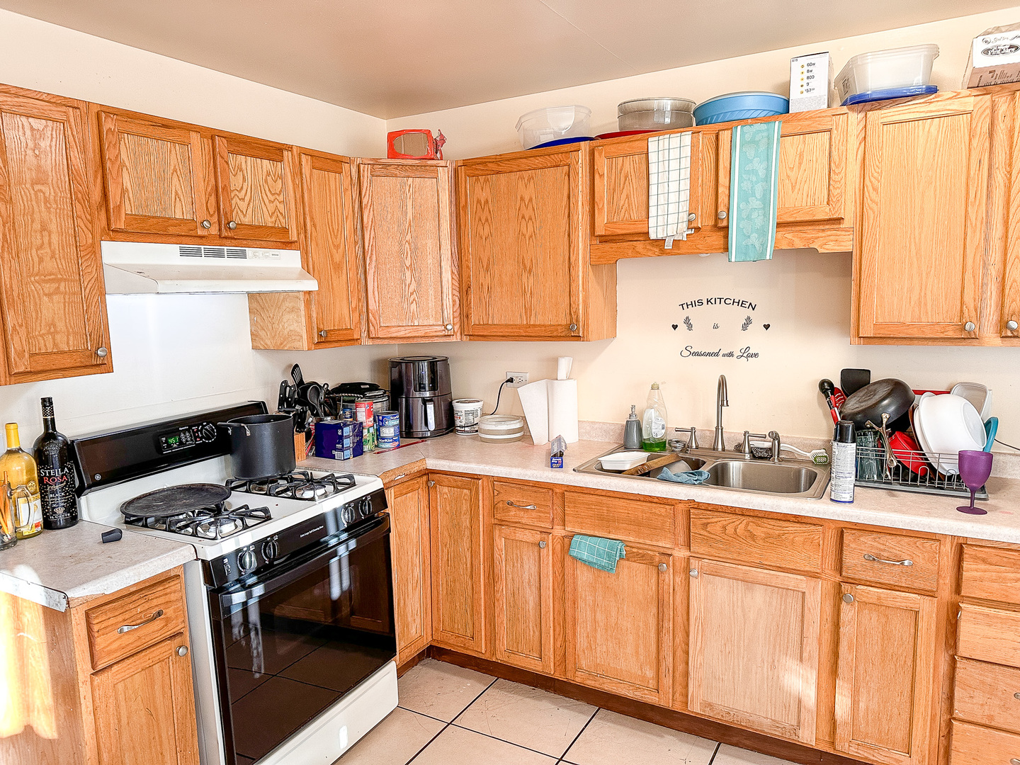 695 Moore Street Kankakee, IL 60901 - Photo 5 of 15 a kitchen with stainless steel appliances granite countertop a sink a stove a refrigerator and cabinets