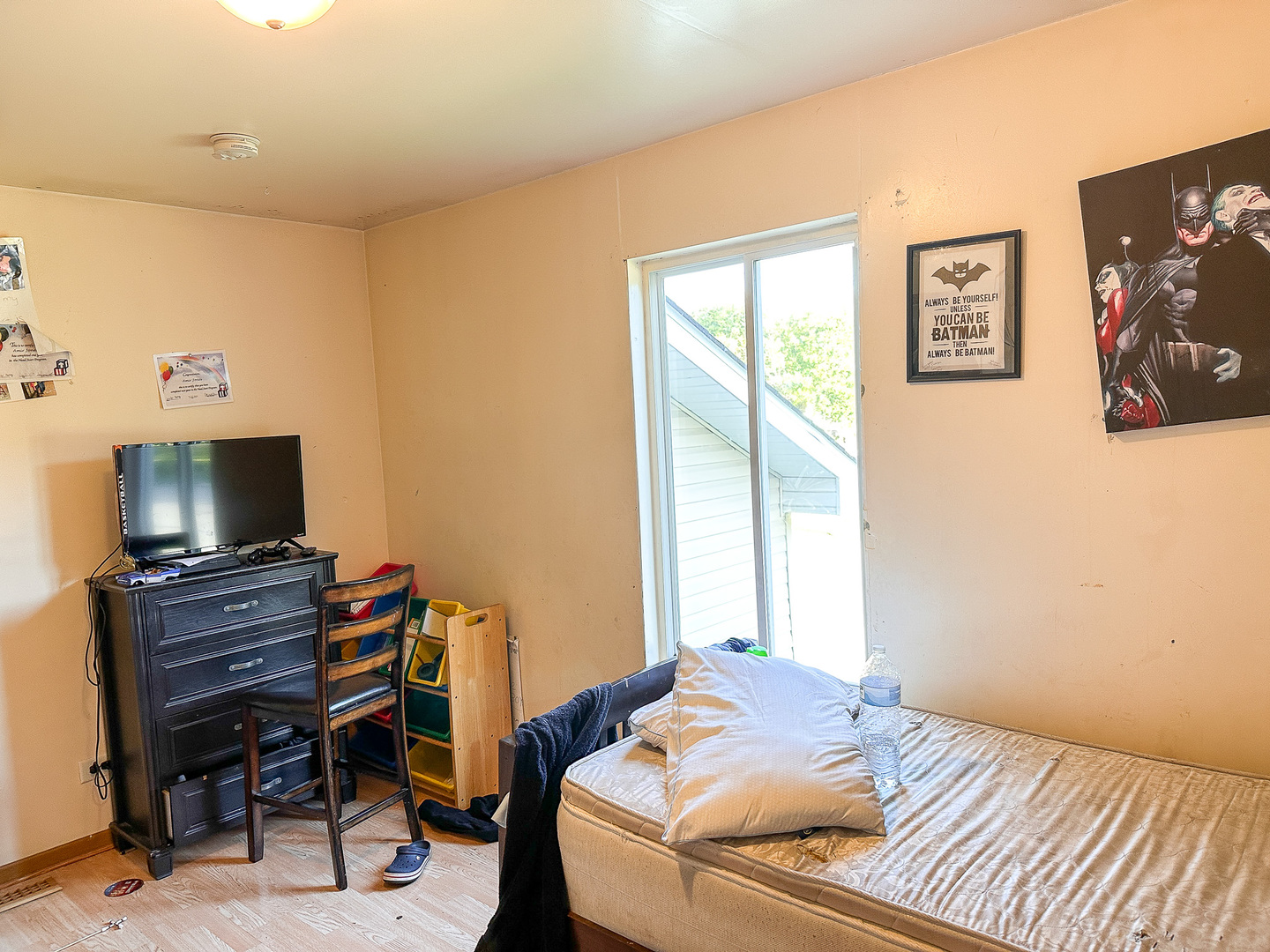 695 Moore Street Kankakee, IL 60901 - Photo 8 of 15 a bedroom with a bed and a flat screen tv