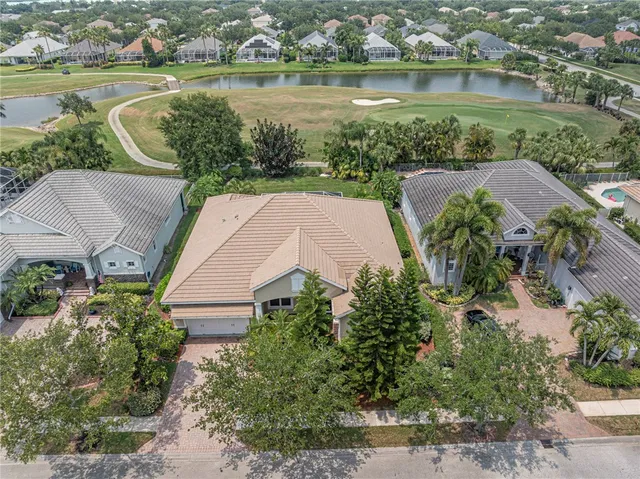 an aerial view of a house with a lake view