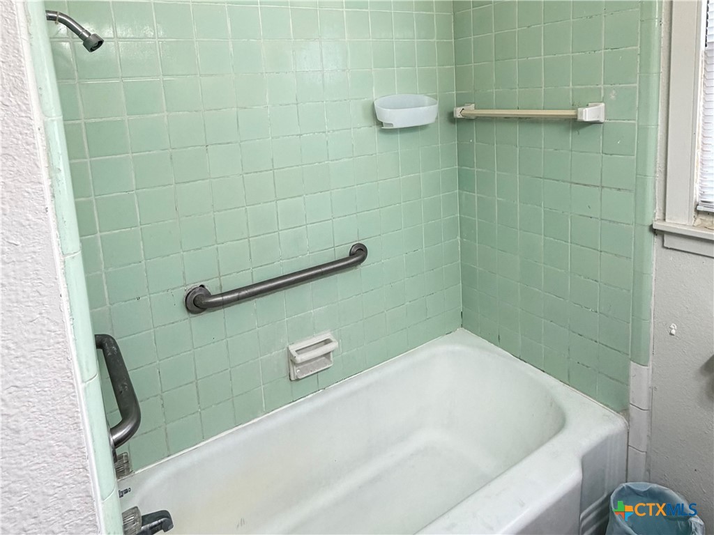 1902 Navidad Street Victoria, TX 77901 - Photo 20 of 23 a bathroom with a white bath tub and shower