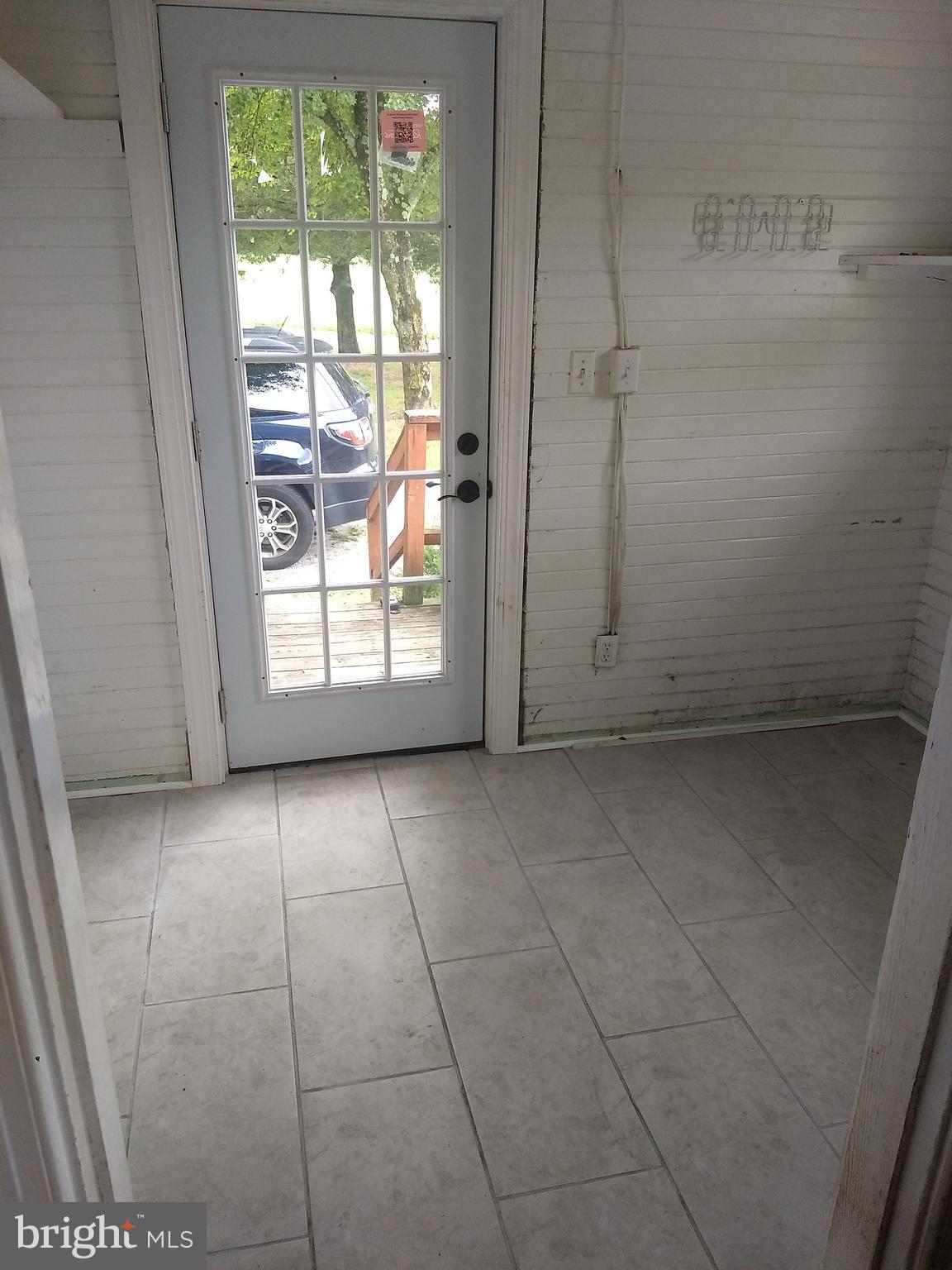 6426 Forest Grove Road Parsonsburg, MD 21849 - Photo 21 of 23 Laundry room entry, with new door and tile floor.